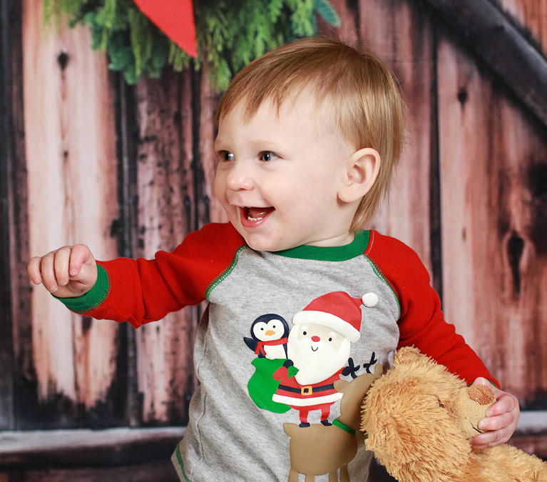 Happy baby boy with teddy bear